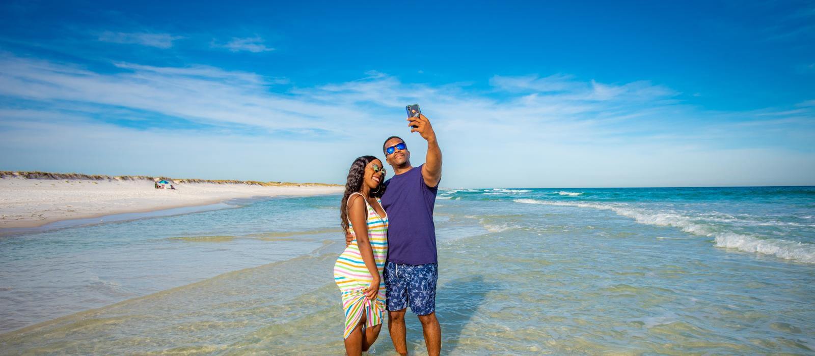 Selfie time on the beach with the most beautiful scenery in as your background.